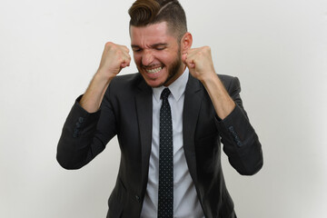 Portrait of handsome bearded Hispanic businessman in suit