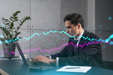 Businessman in office working with laptop technology forex online trading graph and chart, typing computer assemble data drawing concept. Double exposure.
