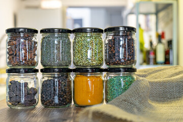 spices and herbs in glass jars for cooking, indian spices, multi colored