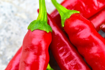 Lots of red fresh chili peppers on the concrete floor