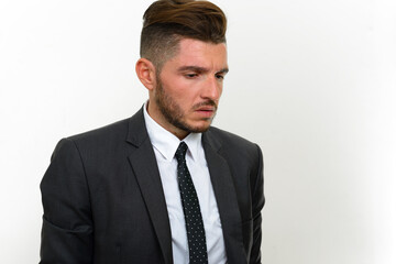 Portrait of handsome bearded Hispanic businessman in suit