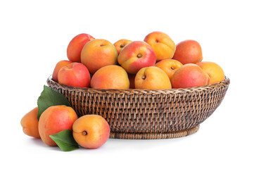 Delicious ripe apricots in wicker bowl isolated on white