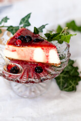Classic New York cheesecake portion with strawberry jam covered. Vintage Mood.