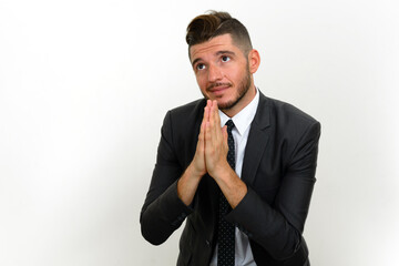 Portrait of handsome bearded Hispanic businessman in suit