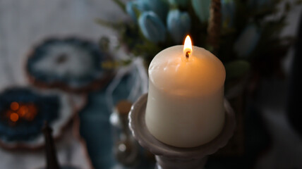 The candle is lit on a dark background.