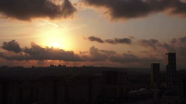 Timelapse beautiful colorful sunset on the cloudy sky over city, Turkey