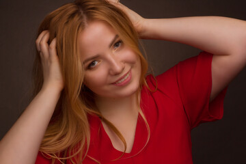 Studio portrait of an overweight young woman with light hair on a black background