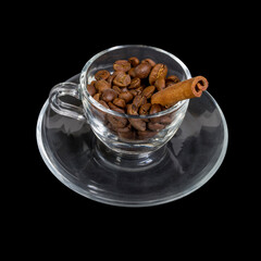 Glass cup on a saucer with coffee grains and a vanilla tube.