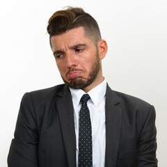 Portrait of handsome bearded Hispanic businessman in suit