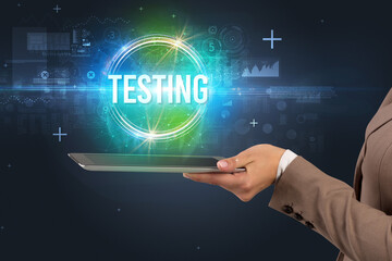 Close-up of a touchscreen with TESTING inscription, new technology concept
