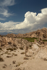 Desert landscape. Geology. View of the arid valley, sandstone and rocky formations under a beautiful blue sky.