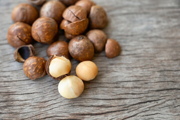 Organic Macadamia nuts with shell on wood table
