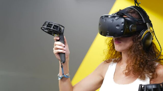 Curvy girl playing game with VR glasses