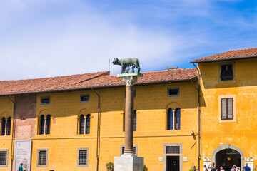 Pisa, Italy - August 14, 2019: The Capitoline Wolf or Lupa Capitolina is a bronze sculpture at Piazza dei Miracoli or Square of Miracles in Pisa