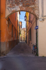 Narrow alley in the old town of Pisa, Tuscany, Italy