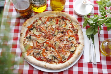 Pizza with ham and zucchini and mozzarella cheese. Italian cuisine.
Traditional Italian pizza. Suggestion to serve a dish. Food background.