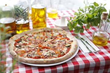 Pizza with ham and zucchini and mozzarella cheese. Italian cuisine.
Traditional Italian pizza. Suggestion to serve a dish. Food background.