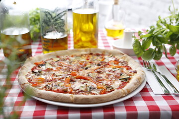 Pizza with ham and zucchini and mozzarella cheese. Italian cuisine.
Traditional Italian pizza. Suggestion to serve a dish. Food background.