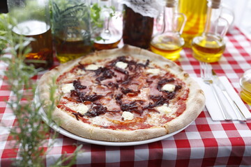 Pizza with ham, red onion jam and goat cheese. Italian cuisine.
Traditional Italian pizza. Suggestion to serve a dish. Food background.