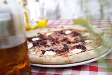 Pizza with ham, red onion jam and goat cheese. Italian cuisine.
Traditional Italian pizza. Suggestion to serve a dish. Food background.