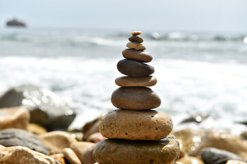 Fototapeta premium a tower of stones on the beach