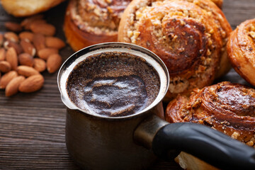 coffee and cinnamon rolls on wooden blackboard