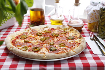 Pizza with salami, green pepper and mozzarella cheese. Italian cuisine.
Traditional Italian pizza. Suggestion to serve a dish. Food background.