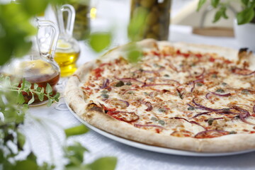 Pizza with tuna, onion, capers, and mozzarella cheese. Italian cuisine.
Traditional Italian pizza. Suggestion to serve a dish. Food background.