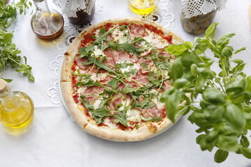 Pizza with ripening ham and arugula.
Traditional Italian pizza. Suggestion to serve a dish. Food background.