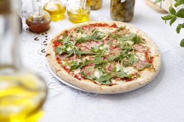 Pizza with ripening ham and arugula.
Traditional Italian pizza. Suggestion to serve a dish. Food background.