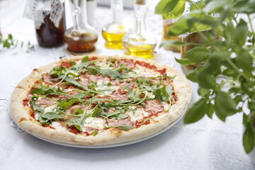 Pizza with ripening ham and arugula.
Traditional Italian pizza. Suggestion to serve a dish. Food background.
