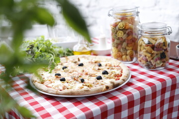 Pizza with artichoke and black olives. Italian cuisine. Traditional Italian pizza. Suggestion to serve a dish. Food background.top view,