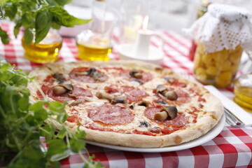 Pizza with salami and mushrooms. Italian cuisine.
Traditional Italian pizza. Suggestion to serve a dish. Food background.