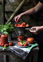 making juice from tomatoes at home kitchen, on a vintage juicer, the old way