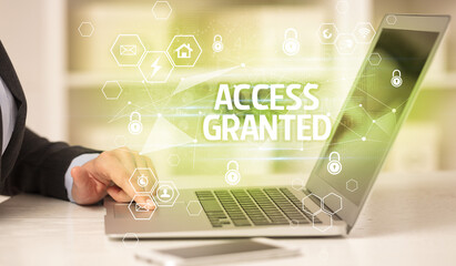 ACCESS GRANTED inscription on laptop, internet security and data protection concept, blockchain and...