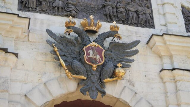 State сoat of arms of the Russian empire on the wall above the gates. Coat of arms of Russia on the building.