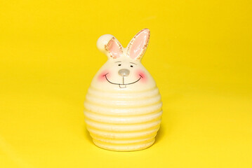 Decoration Bunny with smile on yellow background. Easter bunny decoration on yellow background. close up.