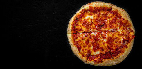 sliced Pizza with Mozzarella cheese, Tomatoes, pepper, Spices. Italian pizza. Pizza Margherita or Margarita on Dark grey black slate background