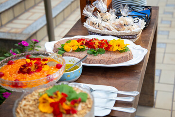 Algumas vasilhas com vários alimentos em mesa de buffet.