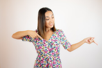 Pretty young woman in dress pointing something