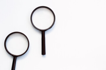 Two magnifying glass on white background