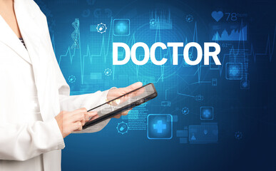 young doctor writing down notes with DOCTOR inscription, healthcare concept