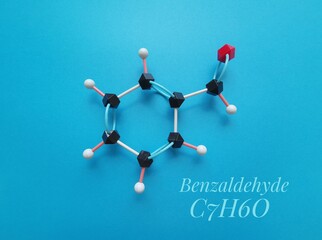 Molecular structure model and chemical formula of benzaldehyde molecule. It is an aromatic aldehyde...
