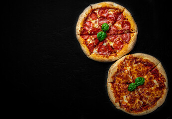 Pepperoni Pizza and Pizza with Mozzarella cheese, Tomatoes, pepper, olive, Spices and Fresh basil. Pizza Margherita or Margarita on Dark grey black slate background