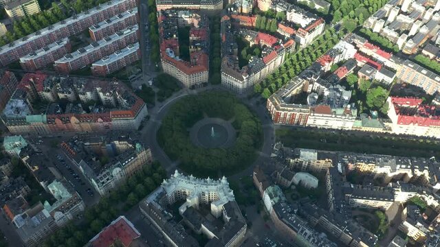 Aerial of the Karlaplan Park, Square and Fountain, in the capital city of Stockholm, Sweden. Flying over the district during sunny day.