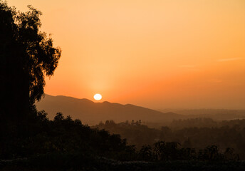 Orange sunset with white setting sun