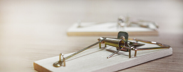 mousetraps without bait on a wooden table, as a business concept