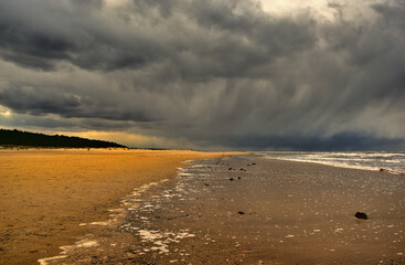 Dark storm cloud over a beach