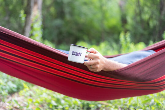 Man In A Hammock Holding A Mug That Says Probably Whiskey