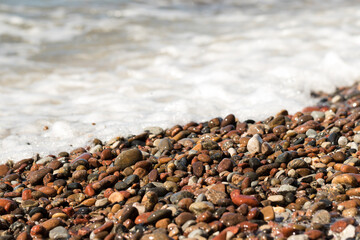 Pebbles on a sandy beach
